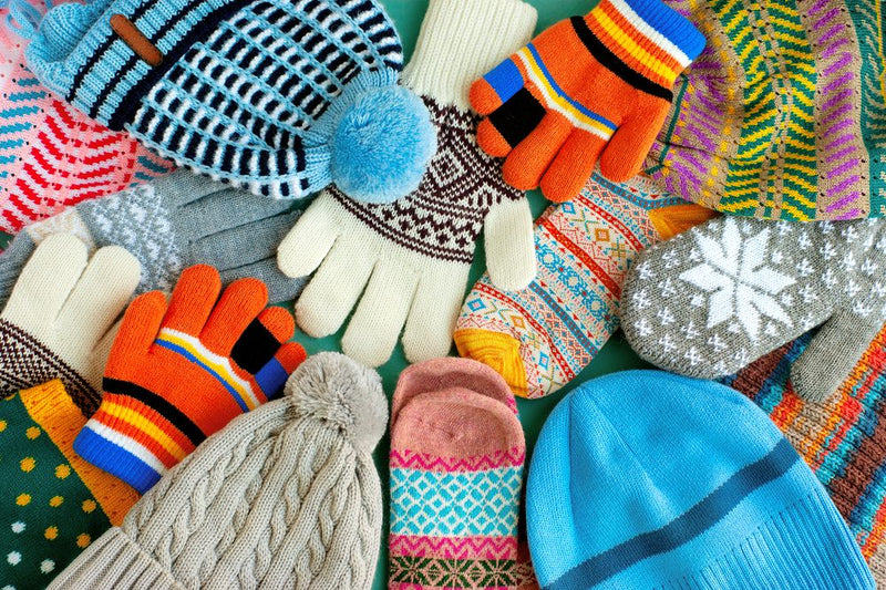 Choosing the Best Winter Fabrics from Your Online Fabric Store. A lot of hats, gloves, mittens. Warm clothes in the form of knitted hats, mittens, gloves, scarves for the cold seasons. Multi-colored clothes for autumn and winter.