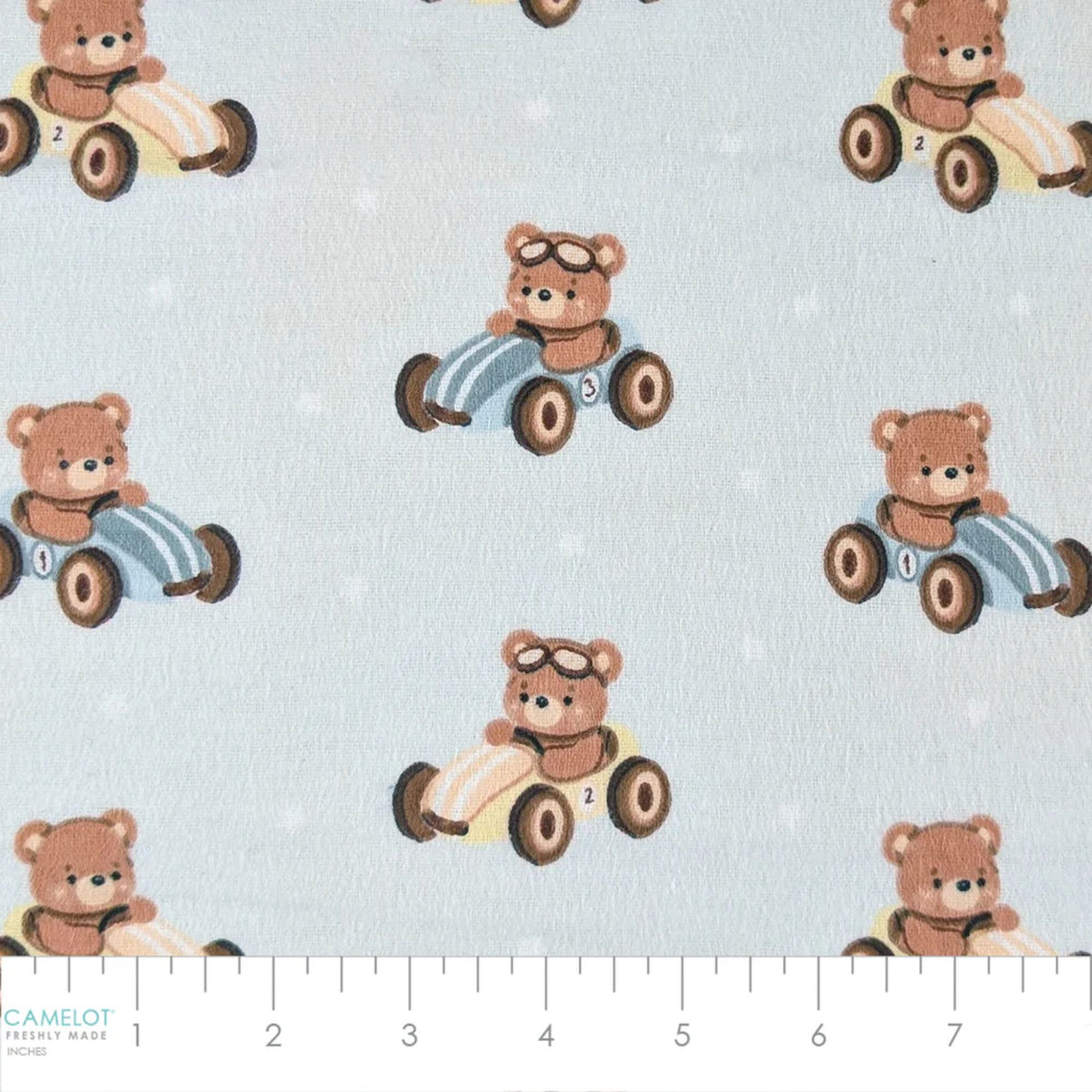 Camelot Fabrics Racing Teddies light blue cotton flannel fabric featuring teddy bears driving vintage toy race cars from the Fleece and Flannel 2026 Collection.