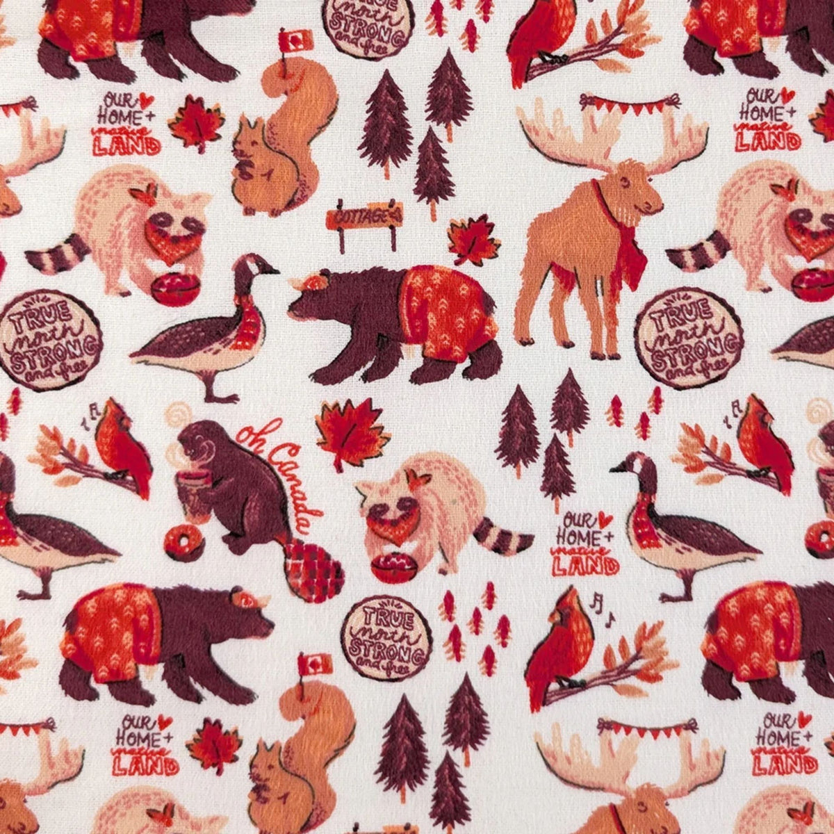 Camelot Fabrics Canadian Animals white cotton flannel fabric featuring bears, moose, beavers, geese, cardinals, and autumn woodland motifs.