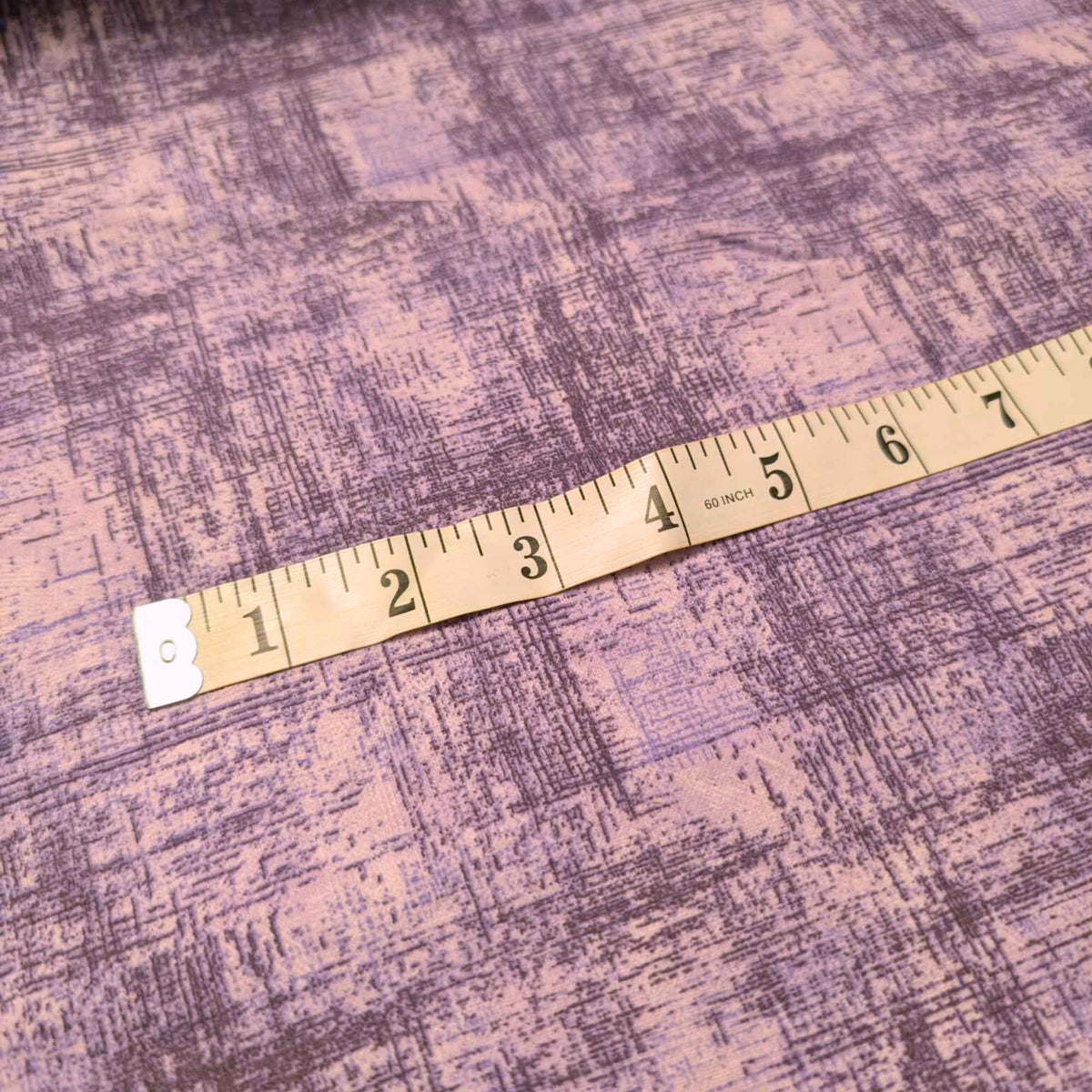 108 inch wide brushed cotton flannel wideback with mauve textured plaid design for seamless quilt backing with tape measure.