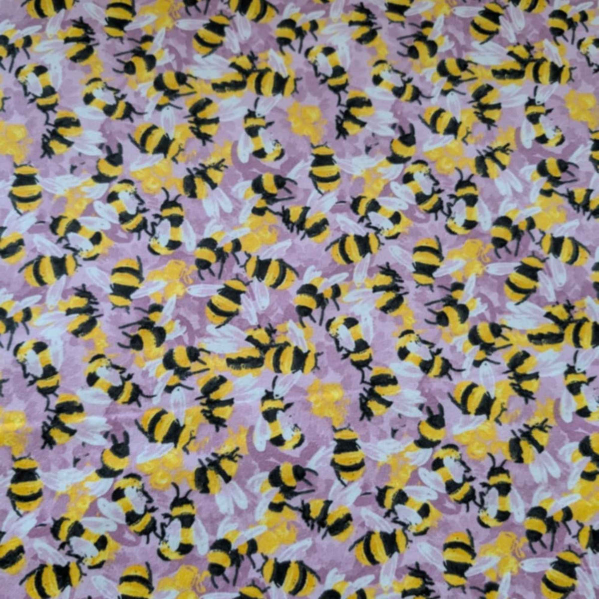 Cotton flannel fabric with yellow and black bees on a pink purple background, brushed for softness, Oeko-Tex certified, 44" wide.