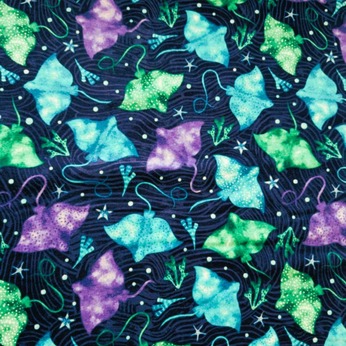 Cotton flannel fabric with colorful stingrays in blue, green, and purple on a dark ocean background with seaweed and starfish. Brushed soft, OEKO-TEX certified, 44 inches wide.