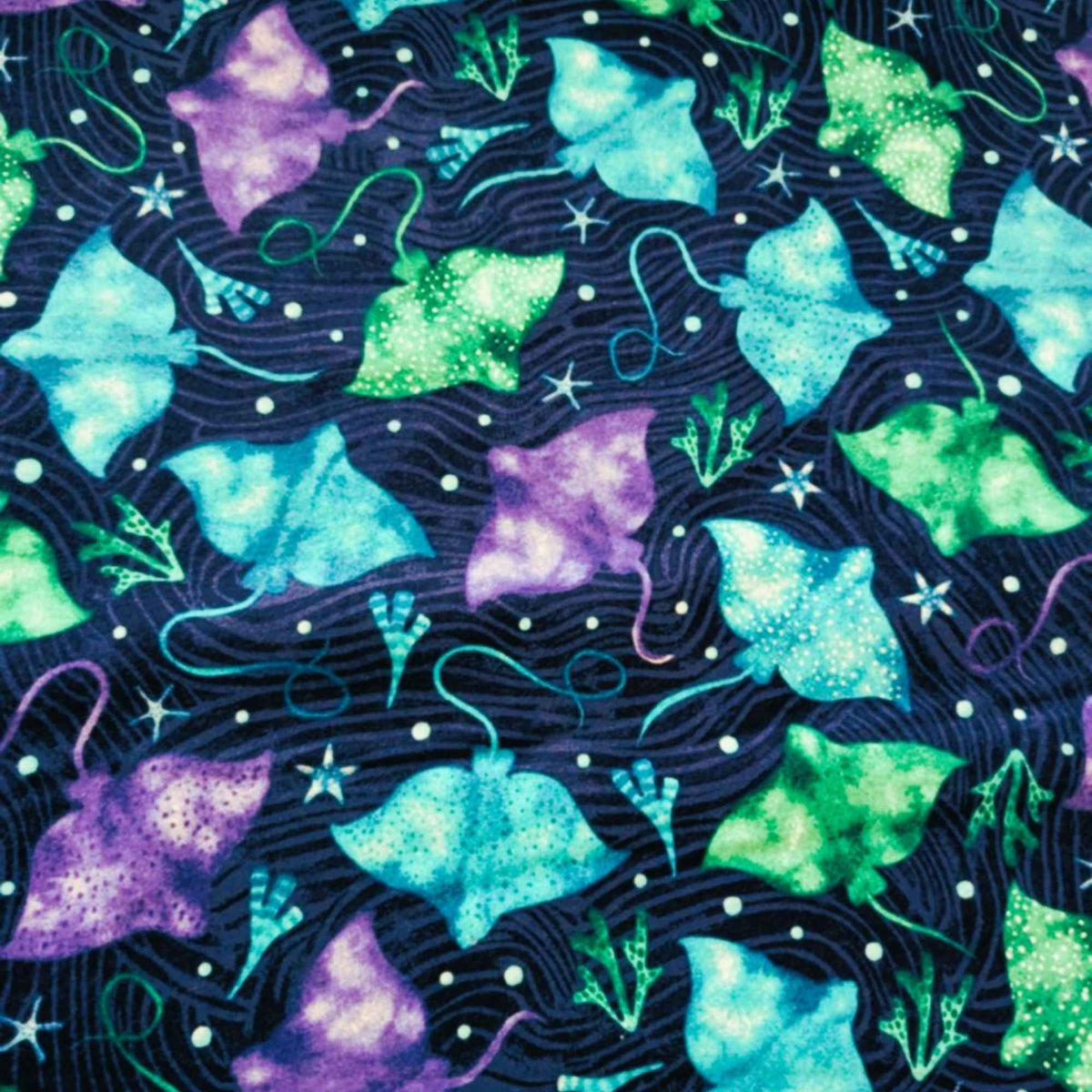 Cotton flannel fabric with colorful stingrays in blue, green, and purple on a dark ocean background with seaweed and starfish. Brushed soft, OEKO-TEX certified, 44 inches wide.