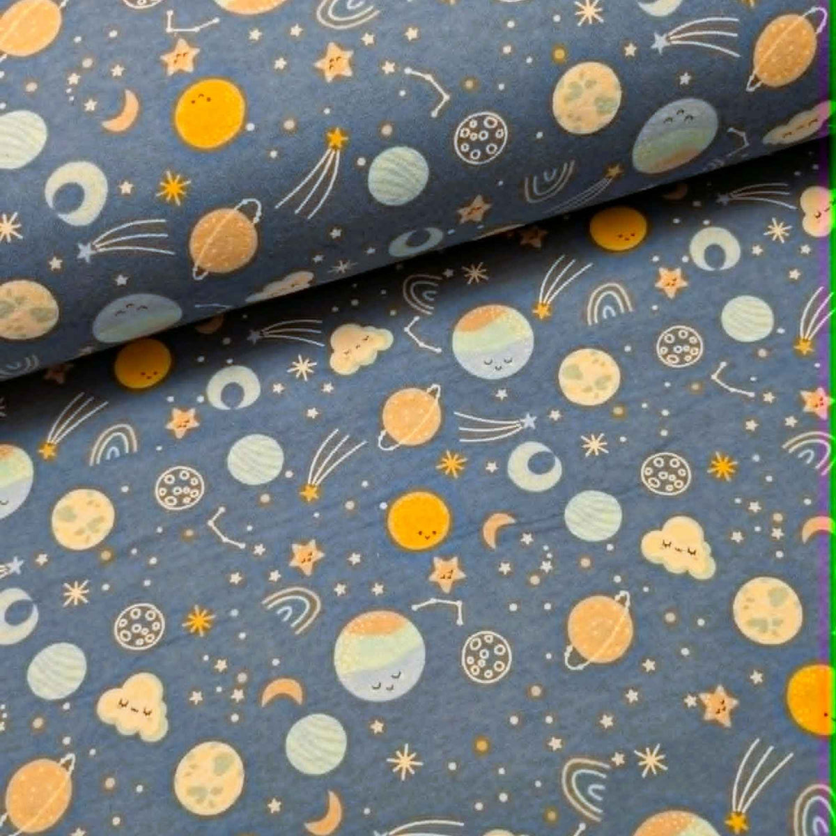Camelot Fabrics Space Friends navy cotton flannel fabric featuring pastel planets, stars, moons, constellations, and shooting stars from the Fleece and Flannel 2026 Collection.
