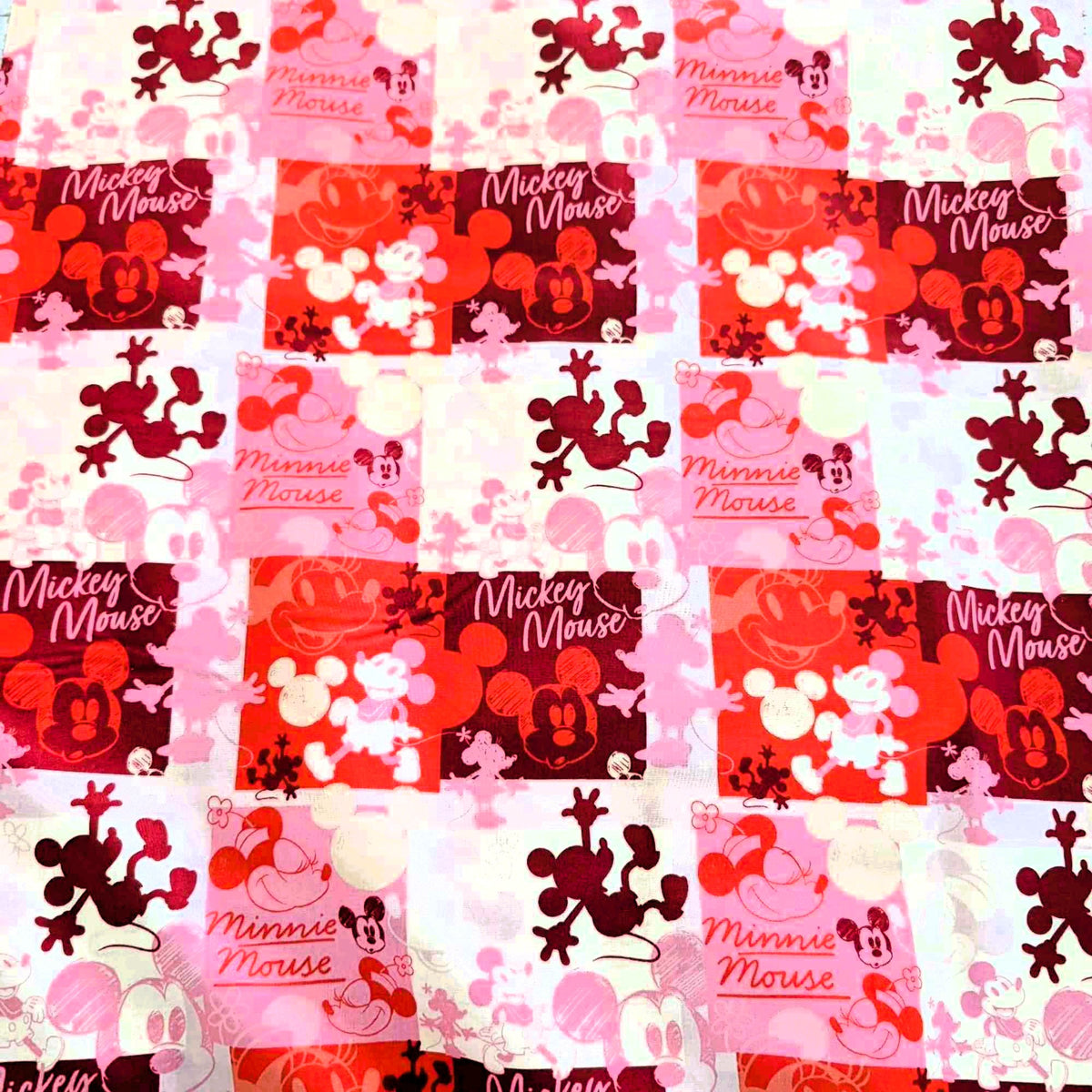 Mickey and Minnie Mouse collage cotton fabric in pink red and cream by Springs Creative CP80470