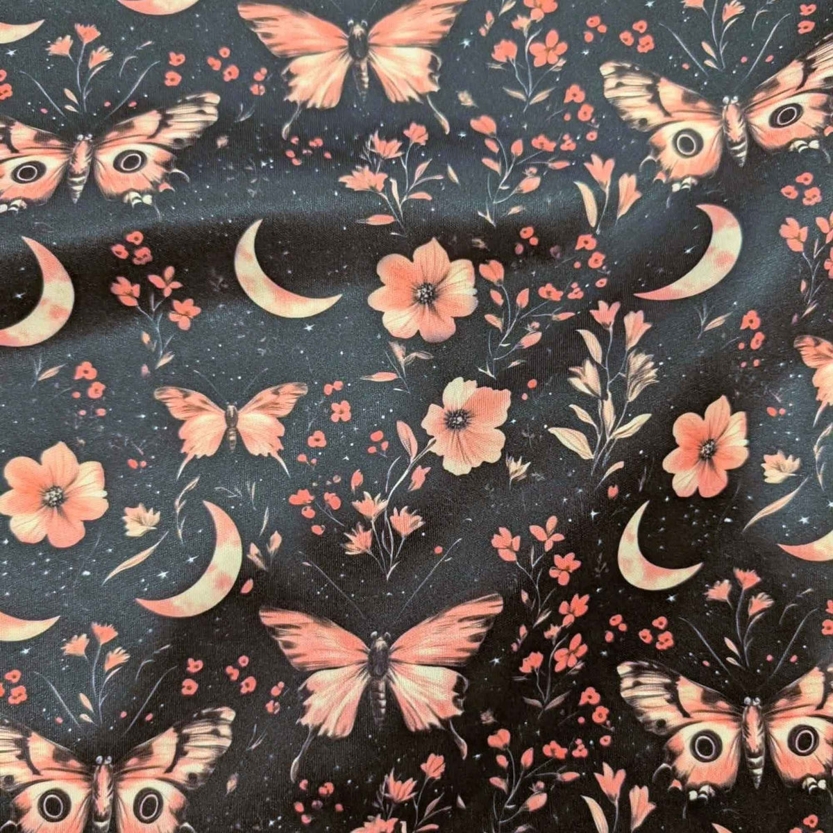 Moonlit Blush Moths exclusive waterproof PUL fabric with pink moths, crescent moons, flowers and stars on a black background