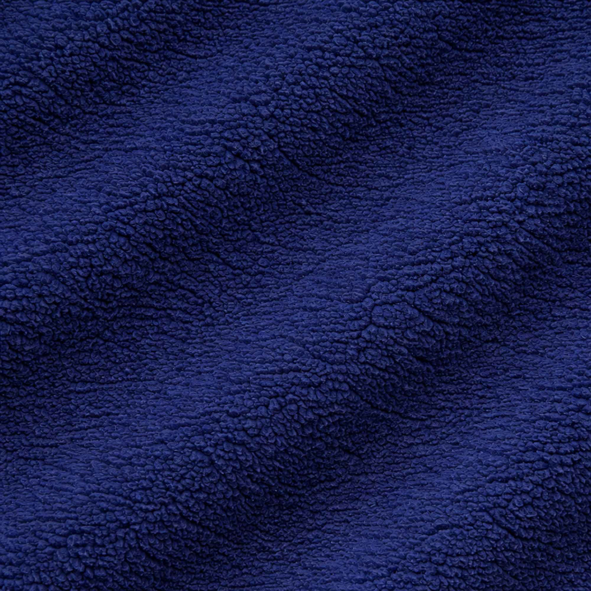 Navy polar fleece fabric texture close-up showing soft anti-pill fleece fibers
