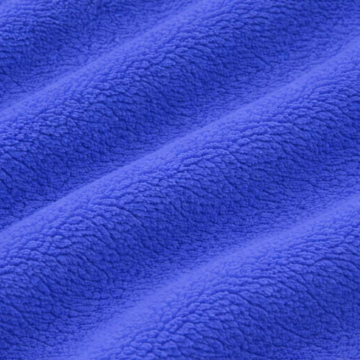 Royal blue anti-pill polar fleece fabric with soft ripple texture, close-up view showing plush fibers and gentle waves.