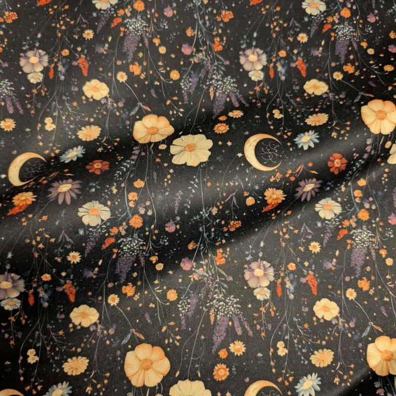 Moonlit Wildflower Garden exclusive waterproof PUL fabric with golden crescent moons and colourful wildflowers on a black background