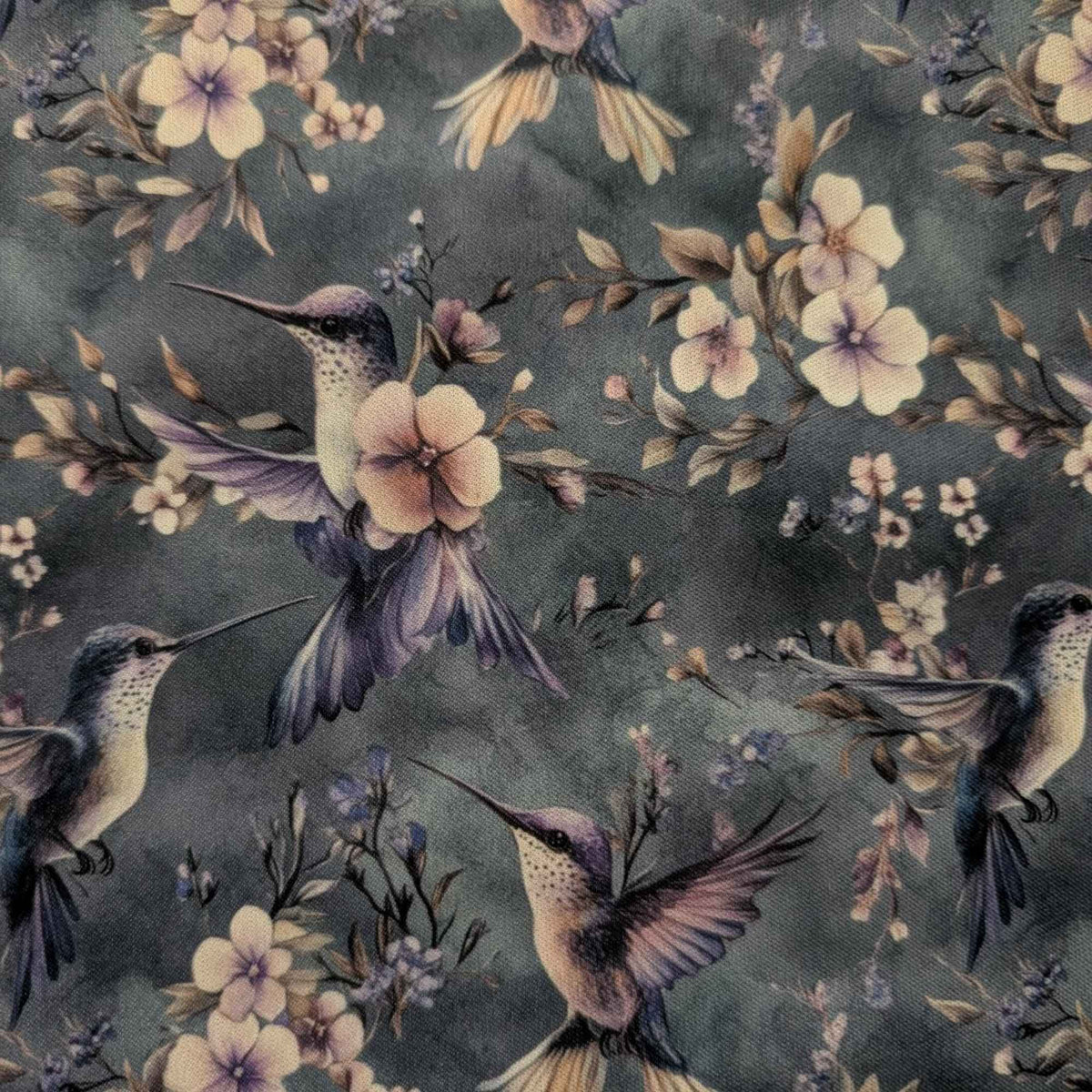 Twilight Hummingbird Garden exclusive waterproof PUL fabric with hummingbirds and soft flowers on a smoky blue-grey background