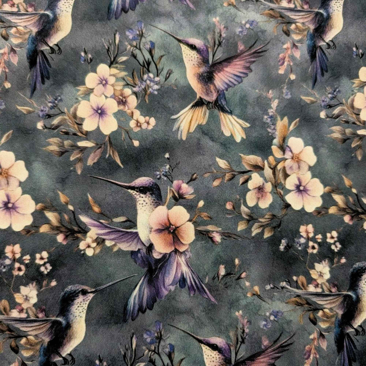 Twilight Hummingbird Garden exclusive waterproof PUL fabric with hummingbirds and soft flowers on a smoky blue-grey background
