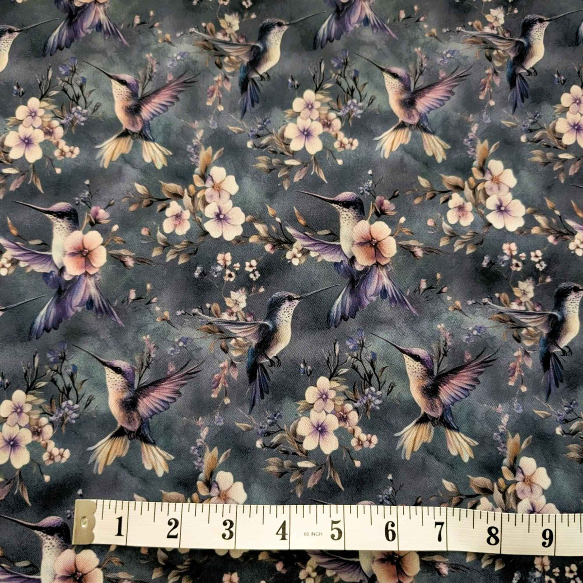 Twilight Hummingbird Garden exclusive waterproof PUL fabric with hummingbirds and soft flowers on a smoky blue-grey background