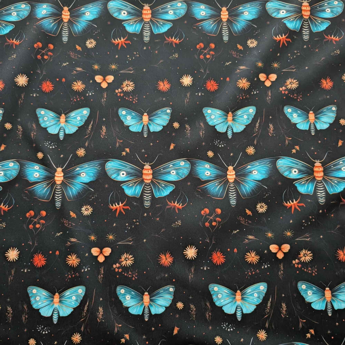 Midnight Blue Moths and Wildflowers exclusive waterproof PUL fabric with turquoise moths and orange flowers on a black background
