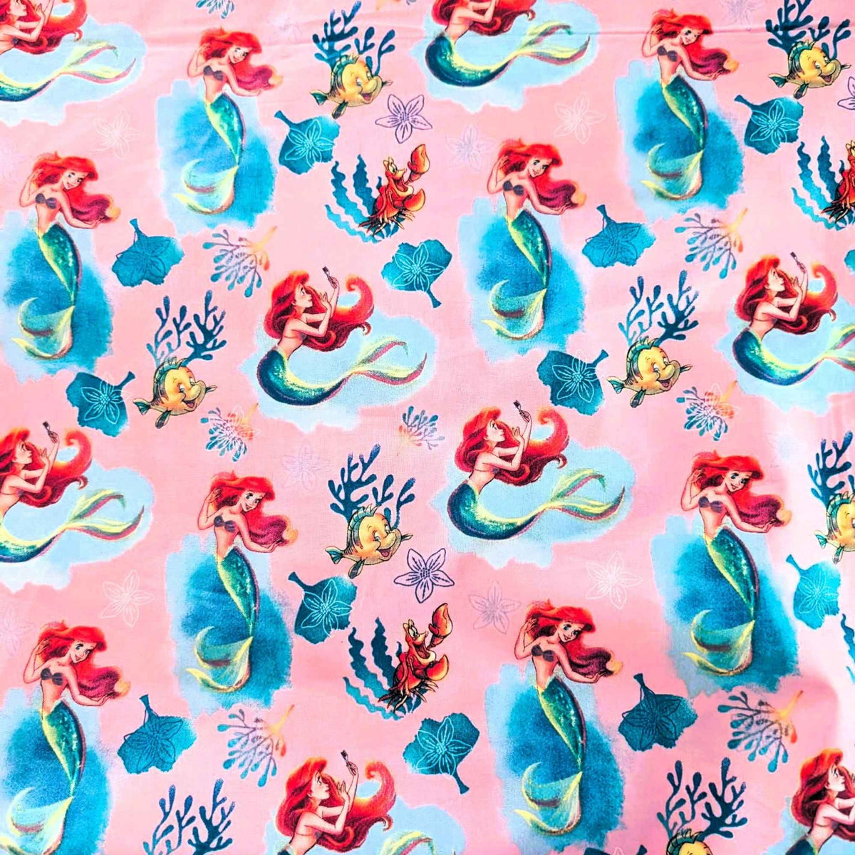 Disney Ariel Little Mermaid cotton fabric with Flounder and Sebastian on pink by Springs Creative CP80606