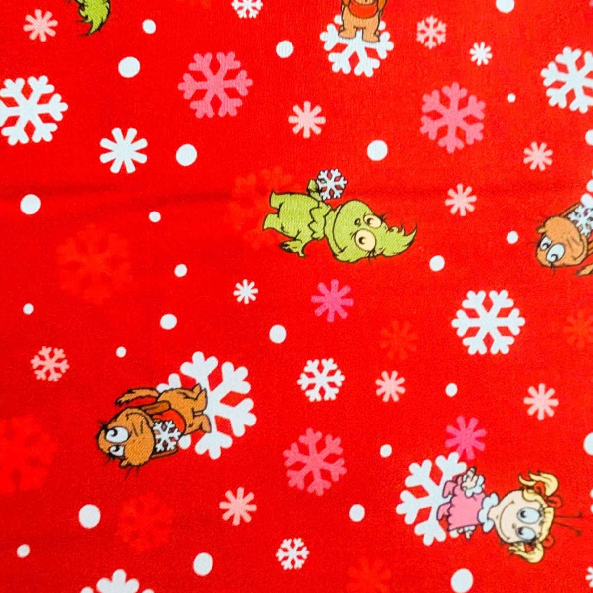 Little Grinch cotton fabric with Grinch characters and snowflakes on red