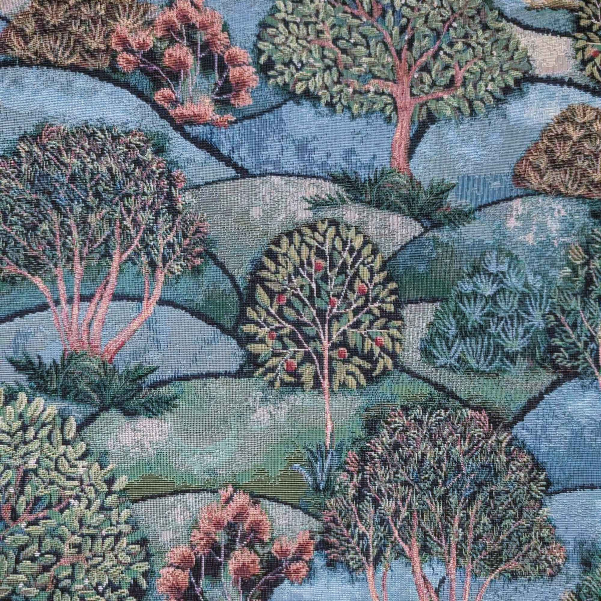 Forest Hill Woodland Trees Gobelin tapestry fabric with leafy trees, muted pink branches and rolling blue and sage green hills.