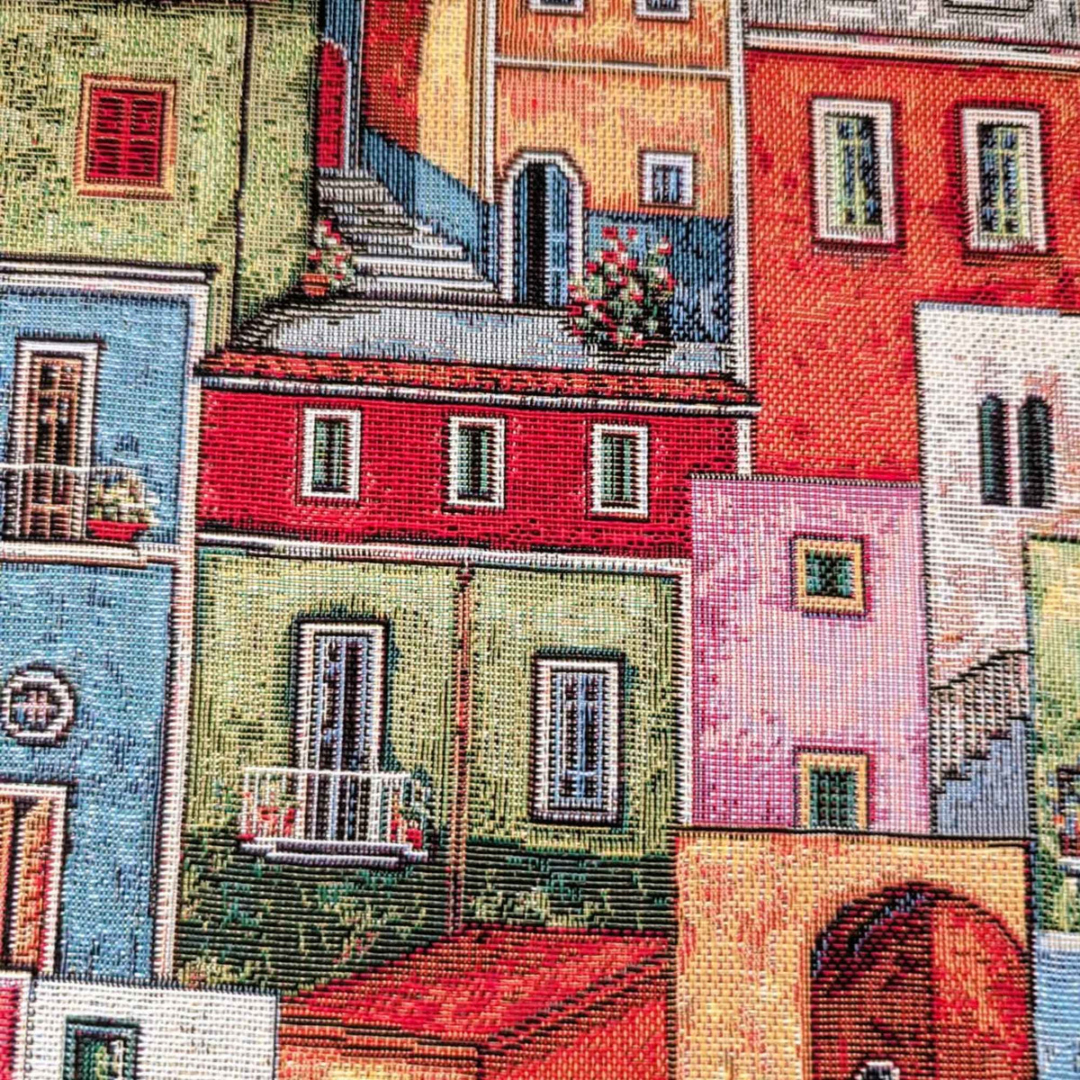 Mediterranean village Gobelin tapestry fabric featuring colourful houses, tiled roofs, balconies, arched doorways and winding stairways.