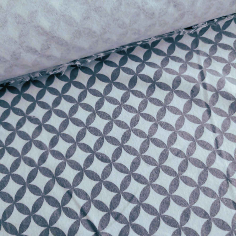 Grey interlocking rings geometric pattern on white 100% cotton flannel fabric, brushed on both sides and ideal for quilting, bedding, blankets, and sewing projects.