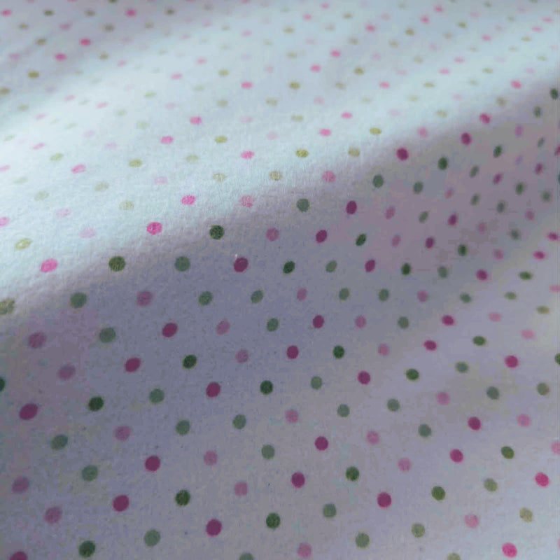 Robert Kaufman Cozy Cotton flannel fabric featuring scattered pink and green dots on a white background, soft two-ply cotton flannel for quilting and sewing projects.