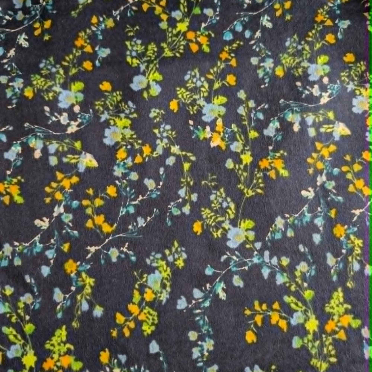 Double brushed flannel fabric featuring delicate yellow, blue, and green wildflowers with trailing vines on a navy background.