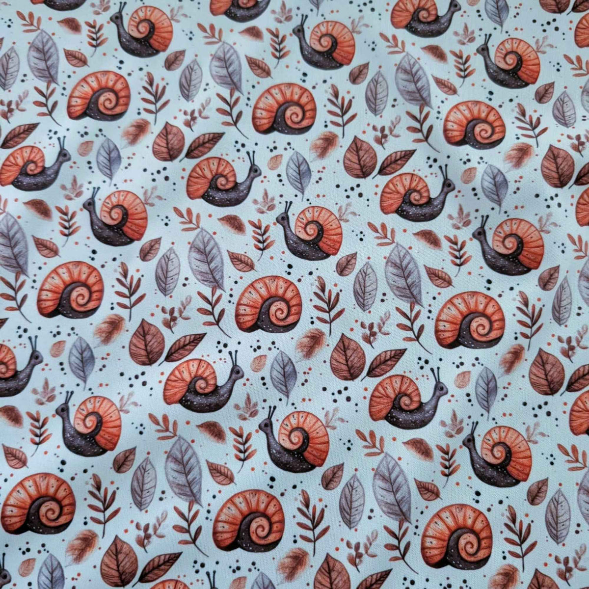 Woodland Snails and Autumn Leaves exclusive waterproof PUL fabric with orange-shelled snails and brown leaves on cream