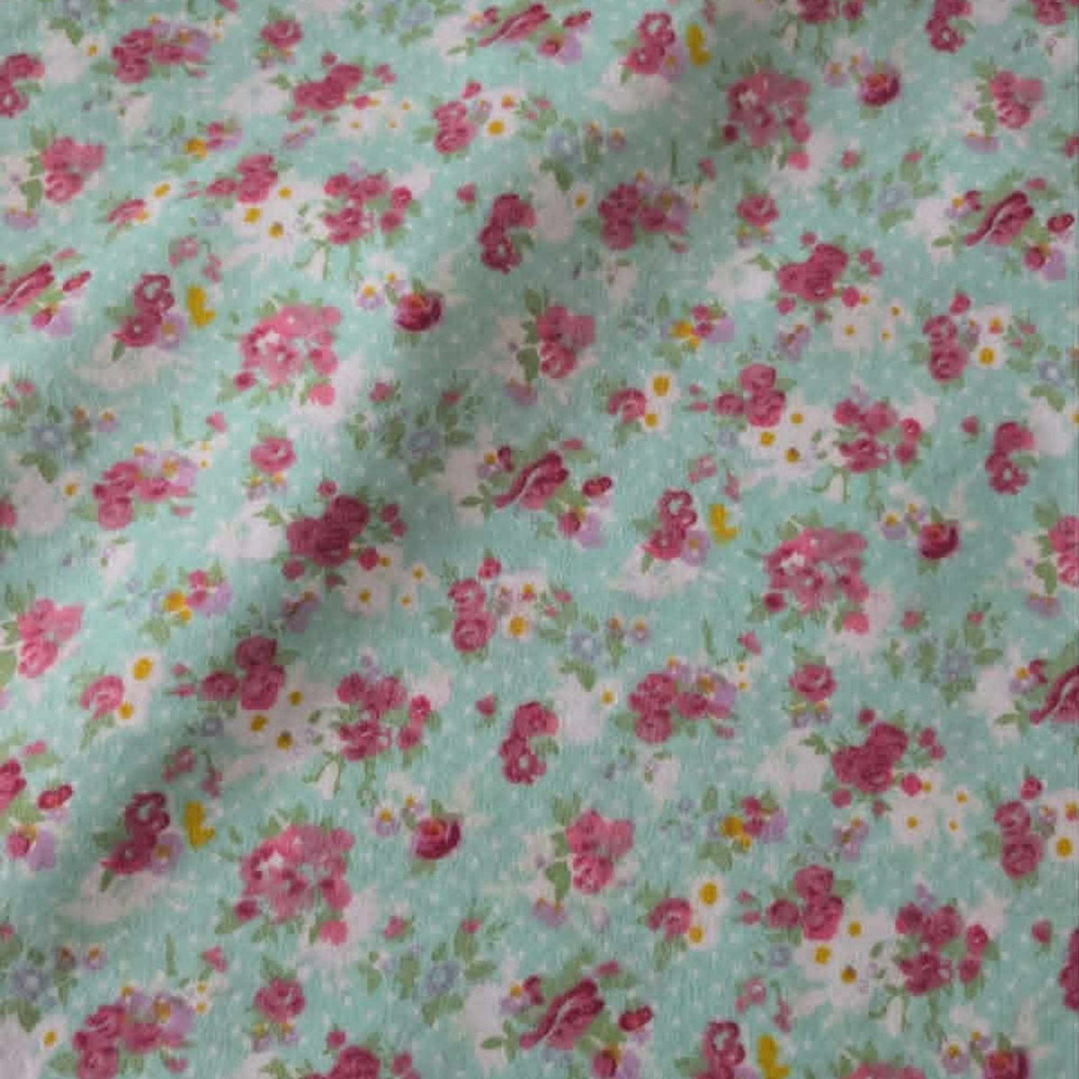 Double brushed flannel fabric featuring pink rose bouquets, delicate wildflowers, and floral sprigs on a soft mint green background.