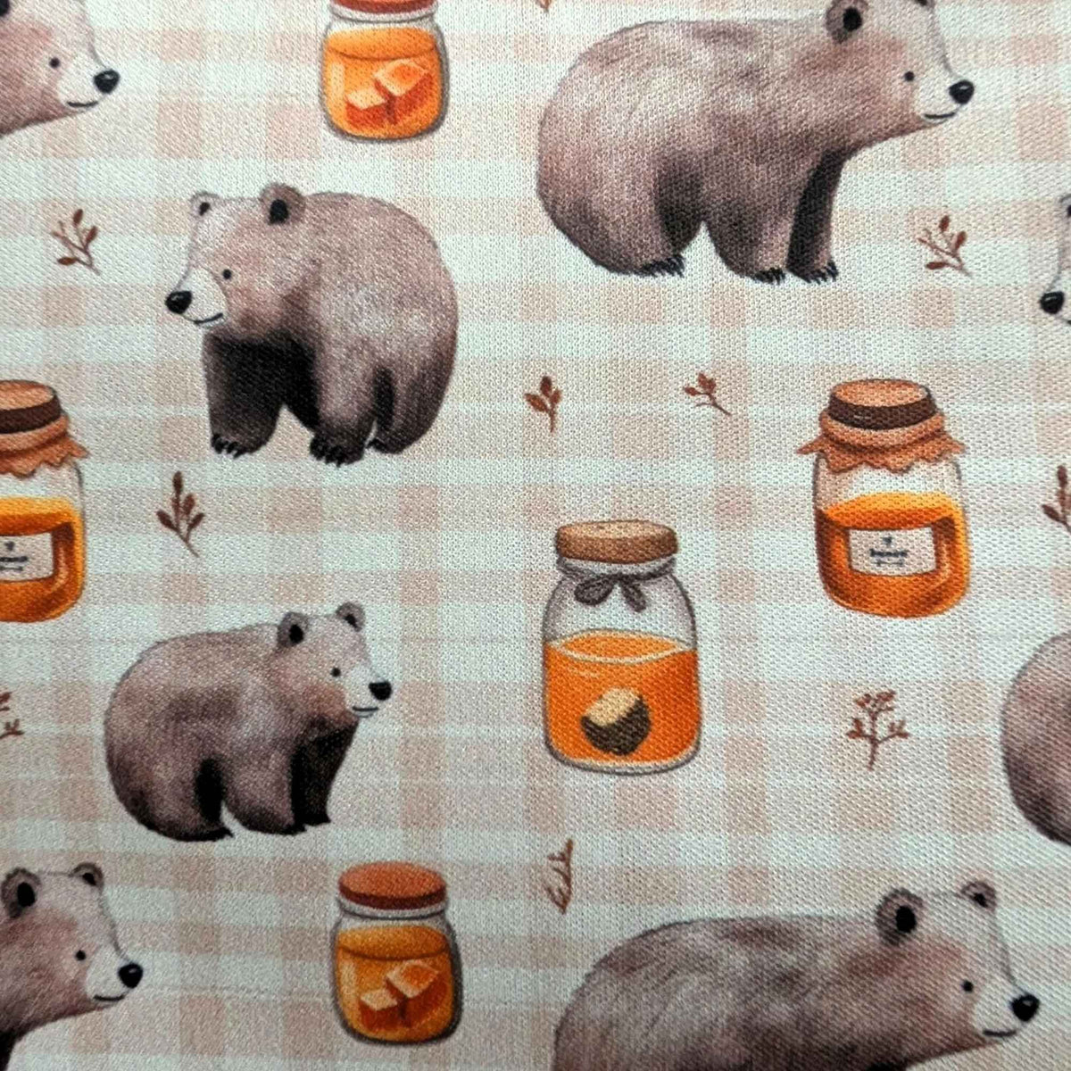 Honey Bear exclusive waterproof PUL fabric with brown bears, golden honey jars and botanical sprigs on a cream checked background
