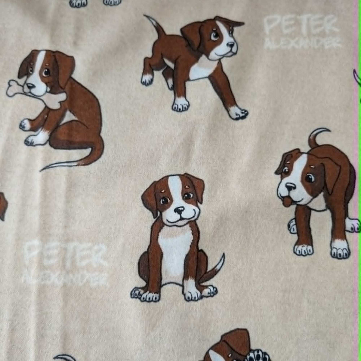 Double brushed flannel fabric featuring playful brown and white puppies in various poses on a cream background.