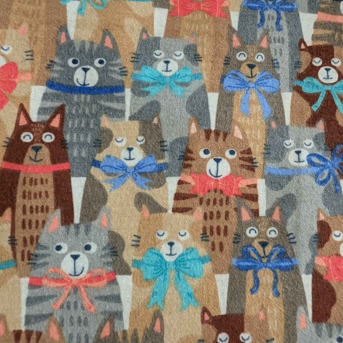 Double brushed flannel fabric featuring whimsical cats wearing colorful bows and collars on a light beige background.
