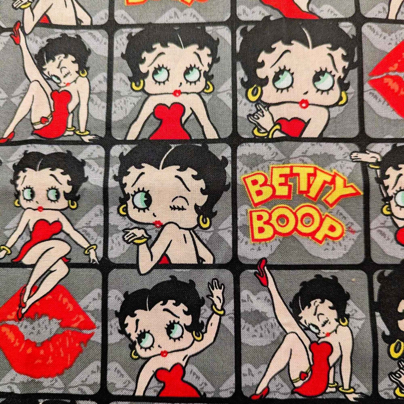 Betty Boop poses in 2" frames on grey fabric