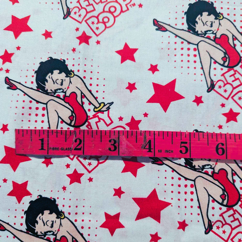 Betty Boop scattered on red polka dot and stars