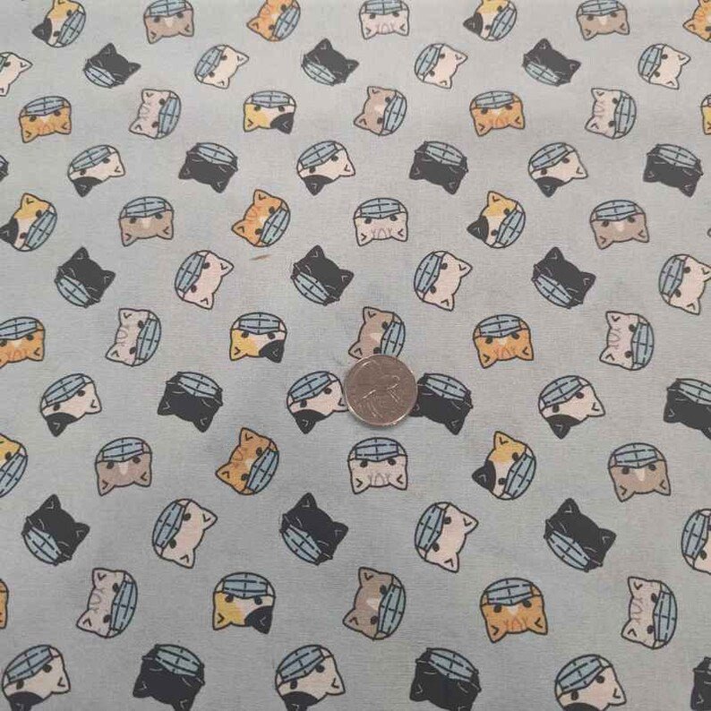 Cat Faces Cotton Fabric – Light Blue Novelty Print with Masks, 44" Wide