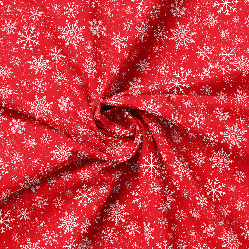 Close-up of red snowflake fabric showing folds and print scale