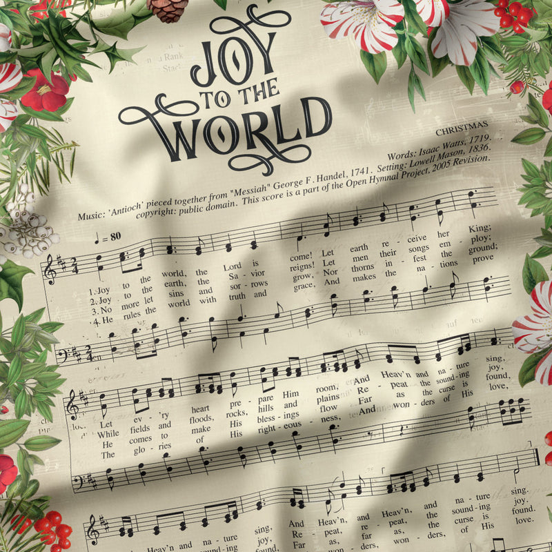 Detail view of Joy to the World Joy to the World Sheet Music Panel quilting cotton showing print scale and drape.