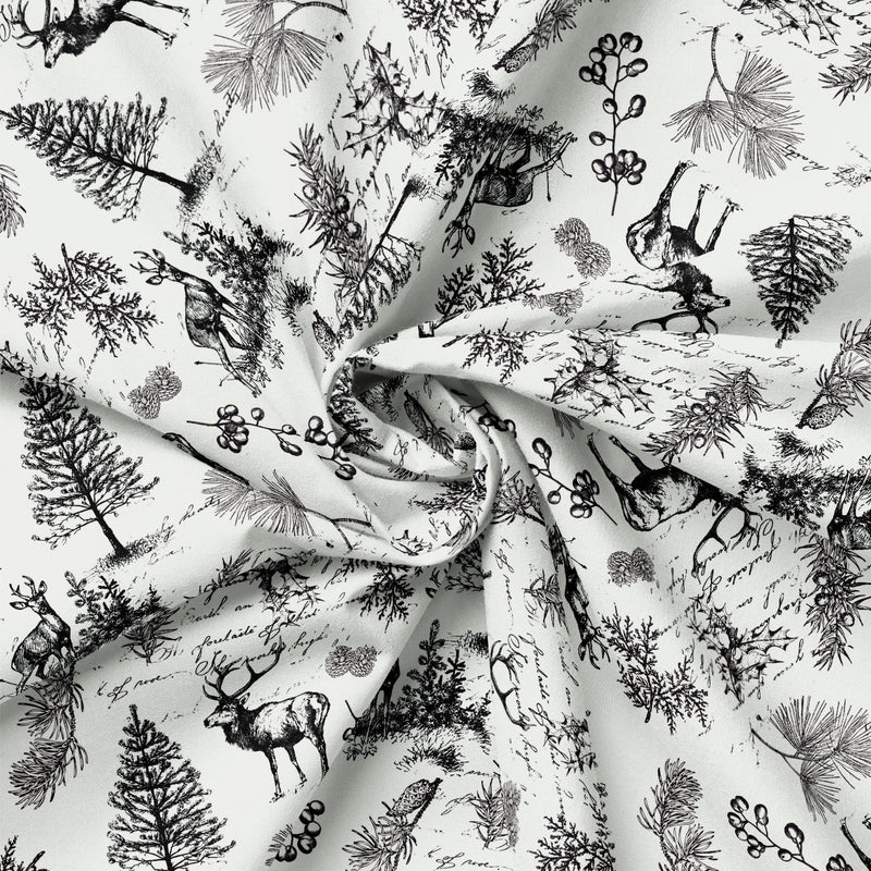 Detail view of Joy to the World Woodland Deer Toile (Black on Cream) quilting cotton showing print scale and drape.
