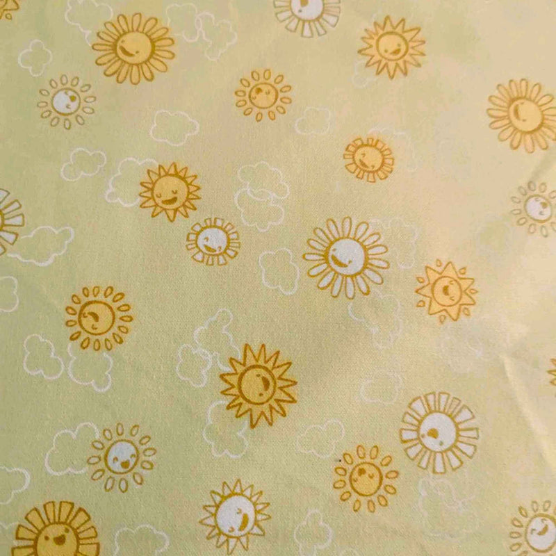 Yellow cotton flannel with smiling orange suns, crescent moons, and white cloud outlines – 44 inches wide brushed Robert Kaufman fabric
